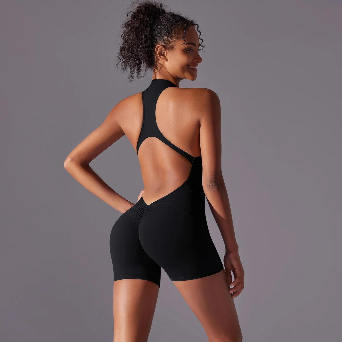 KiKis black backless gym bodysuit for women with racerback design and fitted shorts