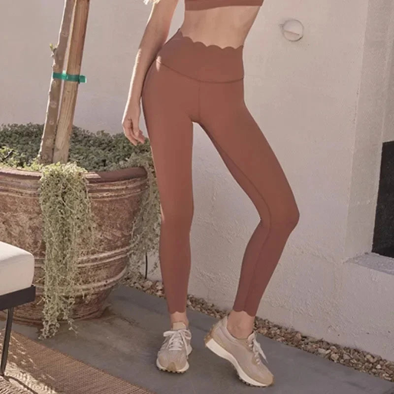 KiKis long sleeve lace back yoga top shown with matching high-waist leggings and sneakers outdoors