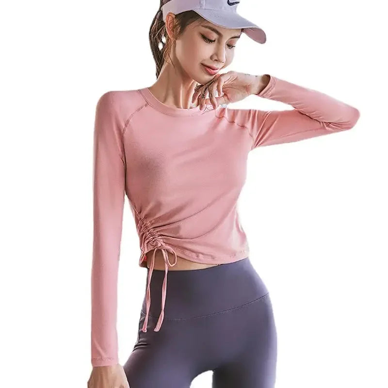 KiKis women's long sleeve yoga top in pink with adjustable side ruching and fitted design