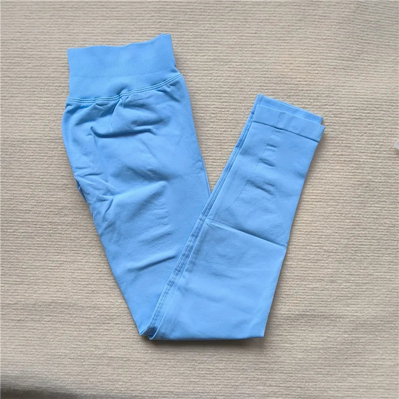 Light blue Women Scrunch Butt Seamless Leggings folded on beige surface by KiKis