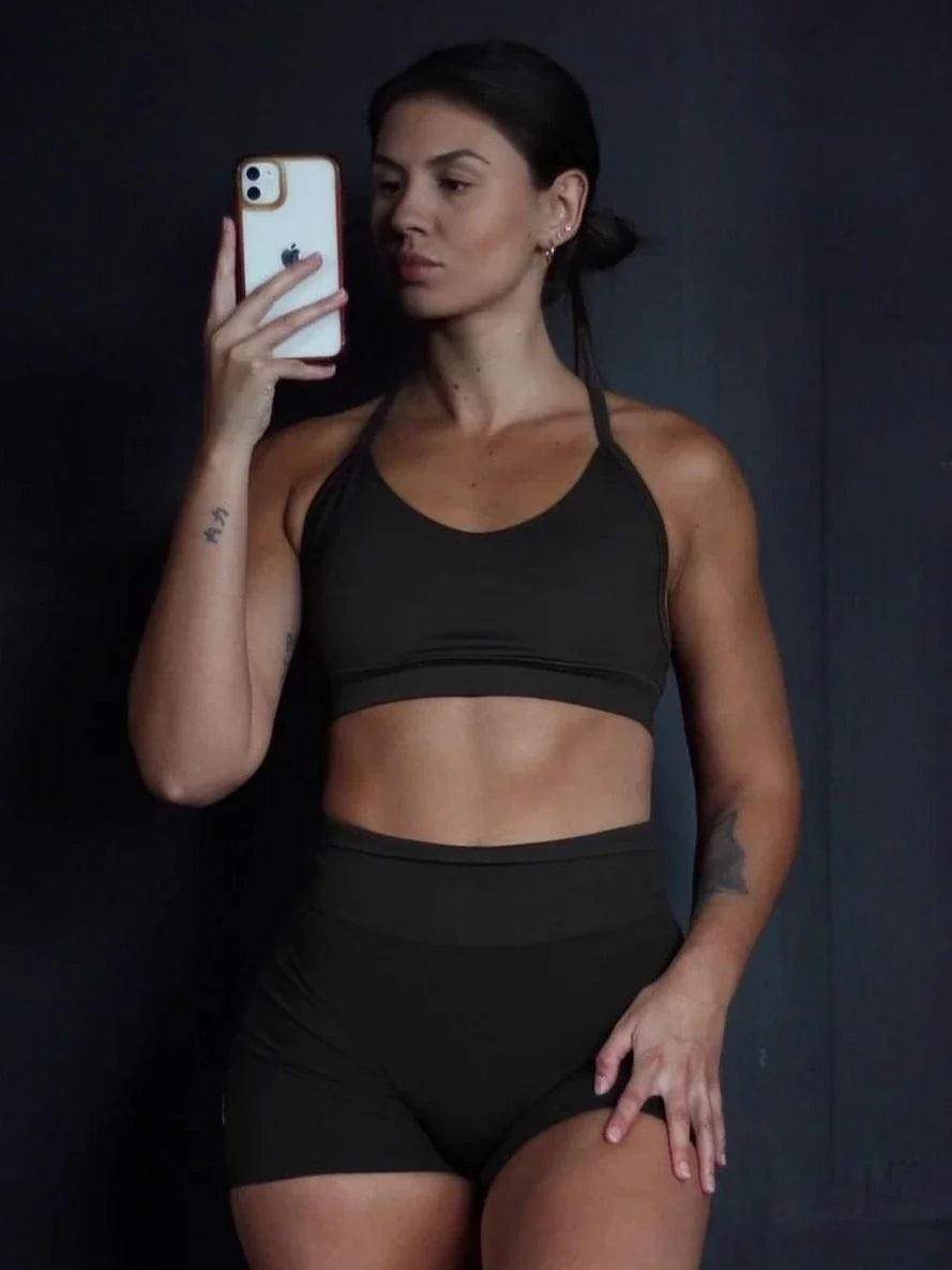 KiKis women's seamless gym set in black featuring a sports bra and high-waisted shorts