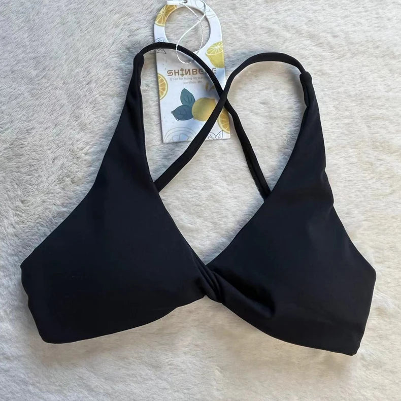 KiKis black padded front twist sports bra with crisscross straps for activewear comfort
