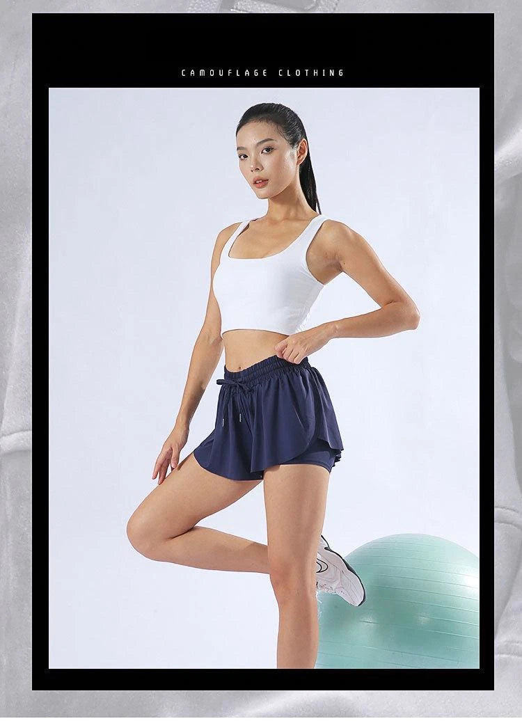 KiKis navy blue yoga running skirt shorts for women worn by model in white tank top