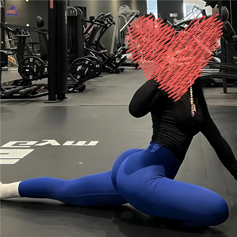 Athlete wearing KiKis Women Scrunch Butt Seamless Leggings in blue stretching on gym floor