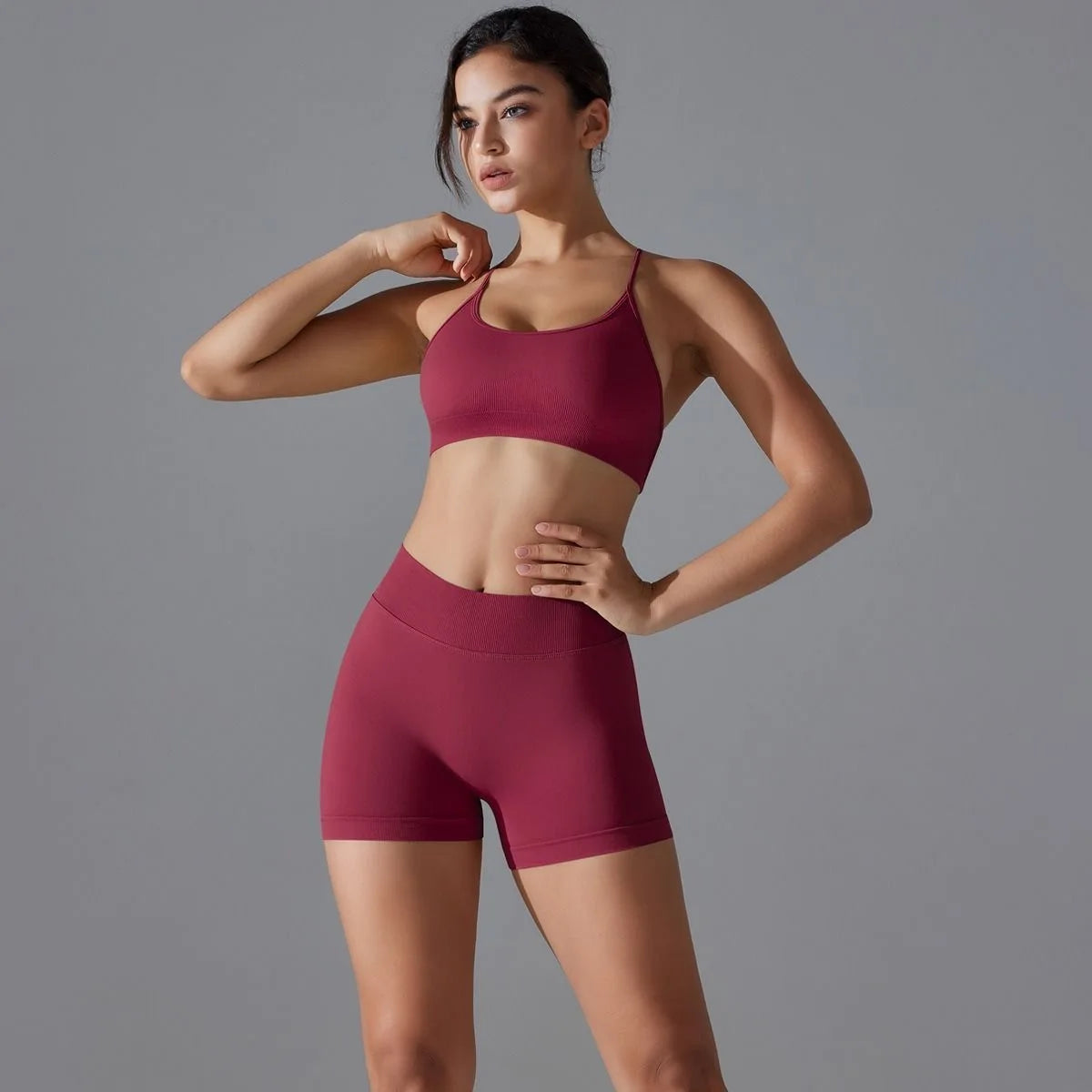 KiKis women's seamless gym set in maroon with a fitted sports bra and high-waisted shorts