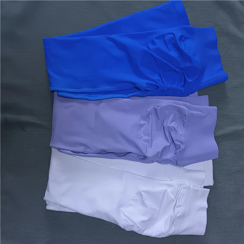 KiKis Women Scrunch Butt Seamless Leggings in blue purple and white colors stacked on gray surface