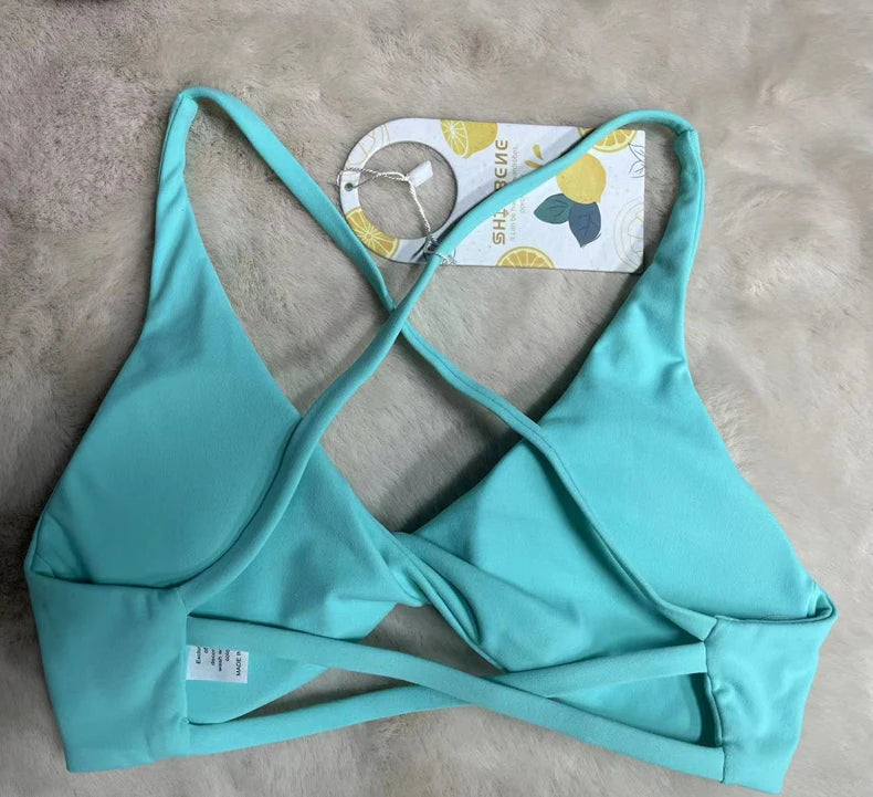 KiKis padded front twist sports bra in light blue with crisscross back straps and soft fabric