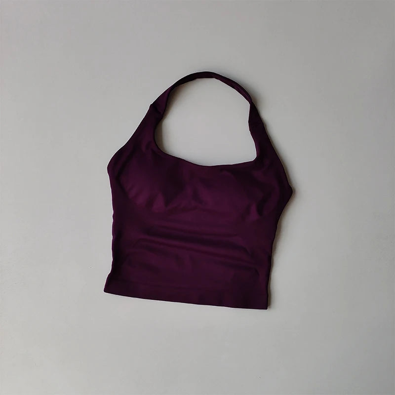 KiKis halter neck sports bra for women in dark purple laid flat on a gray background
