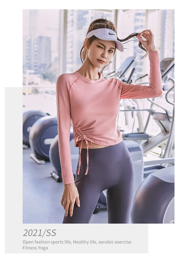 KiKis women's long sleeve yoga top in pink with side drawstring, styled for fitness and aerobic exercise