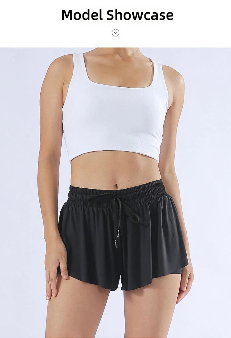 KiKis black yoga running skirt shorts for women worn with white crop top on model