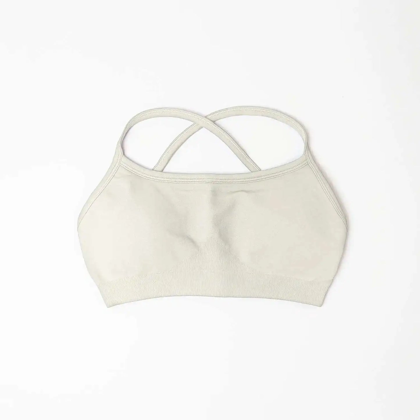 KiKis beige seamless sports bra for women with crossed back straps and soft fabric