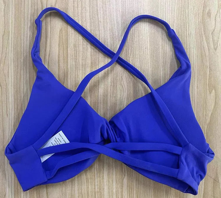 KiKis padded front twist sports bra in solid purple with adjustable shoulder straps