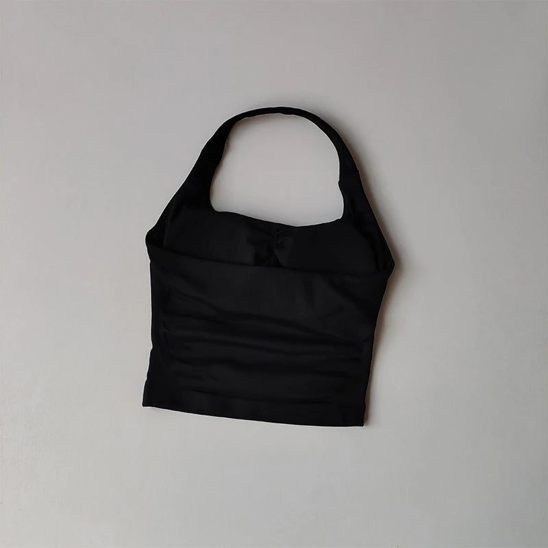 Black halter neck sports bra for women by KiKis with a sleek and supportive design