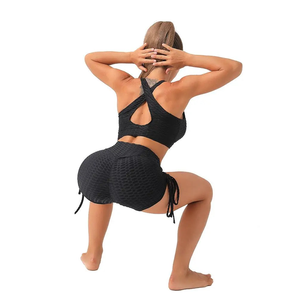 Woman wearing black push up sport shorts women with textured fabric and ruching detail from KiKis