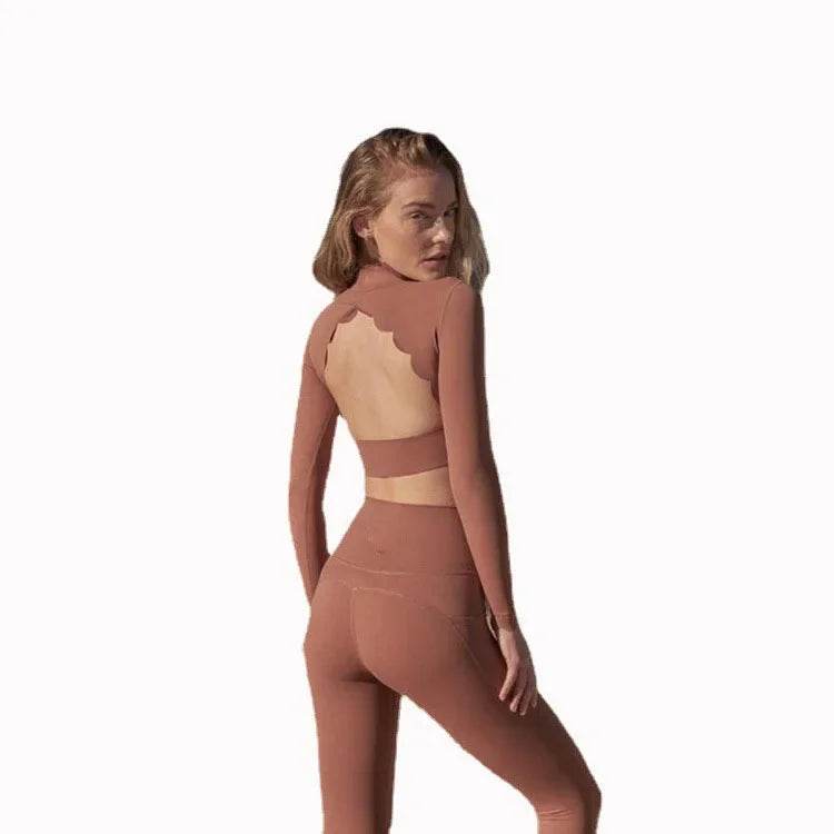 Woman wearing a brown long sleeve lace back yoga top with matching leggings from KiKis