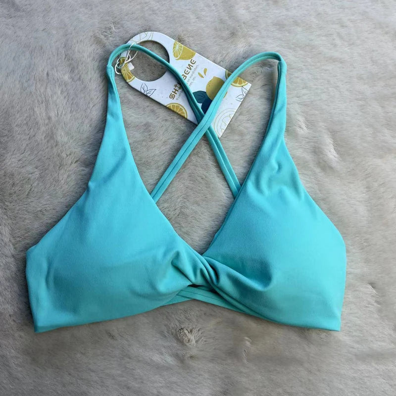 KiKis padded front twist sports bra in light blue with thin crossed straps for support