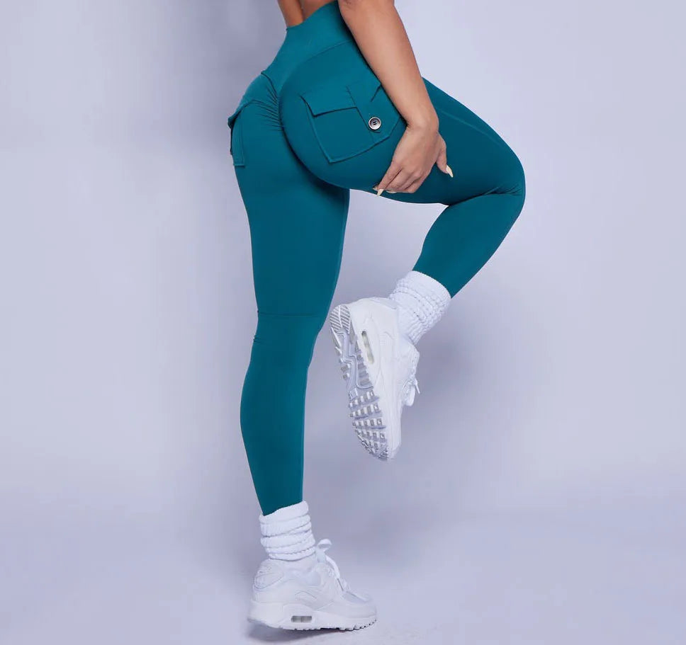 KiKis women's scrunch booty shorts styled as teal high-waisted leggings with pocket details