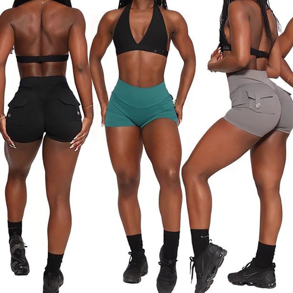 Three women wearing KiKis women's scrunch booty shorts in black teal and gray with sporty black tops and sneakers