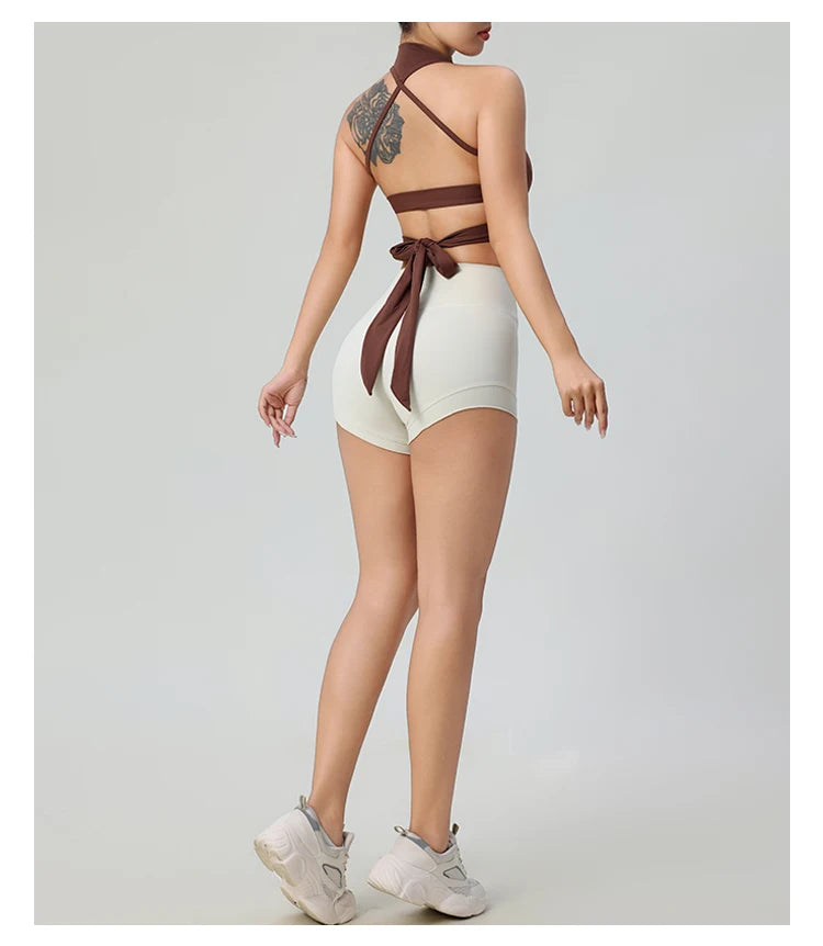 Woman wearing comfortable workout tank tops for women in brown with crisscross back and tie detail