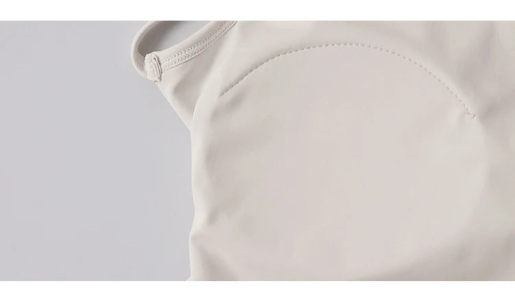 Close-up of KiKis beige comfortable workout tank tops for women showing soft fabric and stitching details