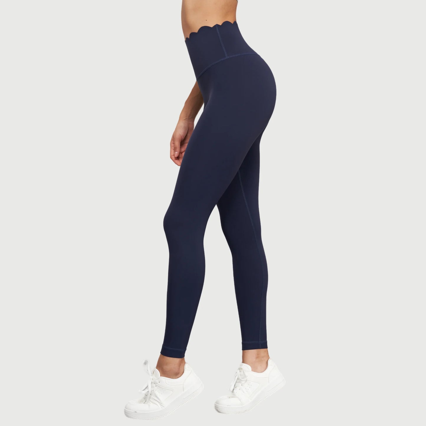 KiKis Women Seamless Lotus Arc Yoga Pants in navy blue with scalloped high waistband