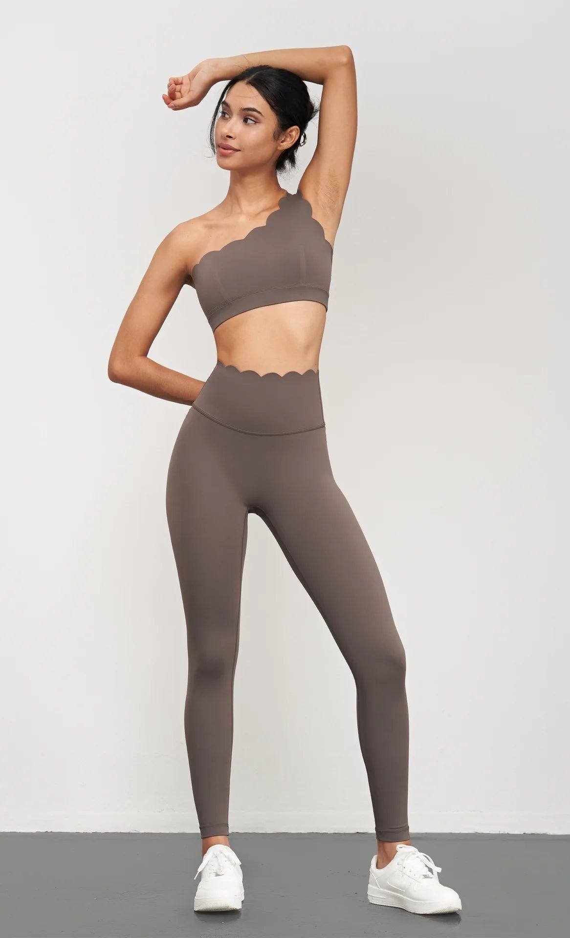 KiKis Women Seamless Lotus Arc Yoga Pants in brown high-waisted fit worn with matching scalloped crop top