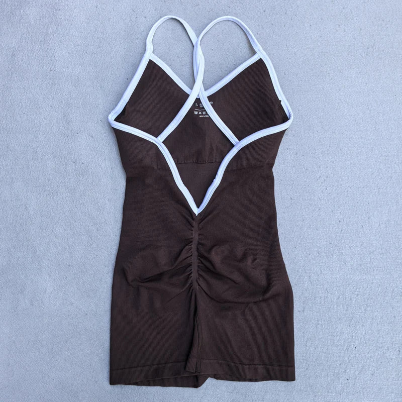 KiKis black cross back strappy jumpsuit with white trim and ruched detail on the back