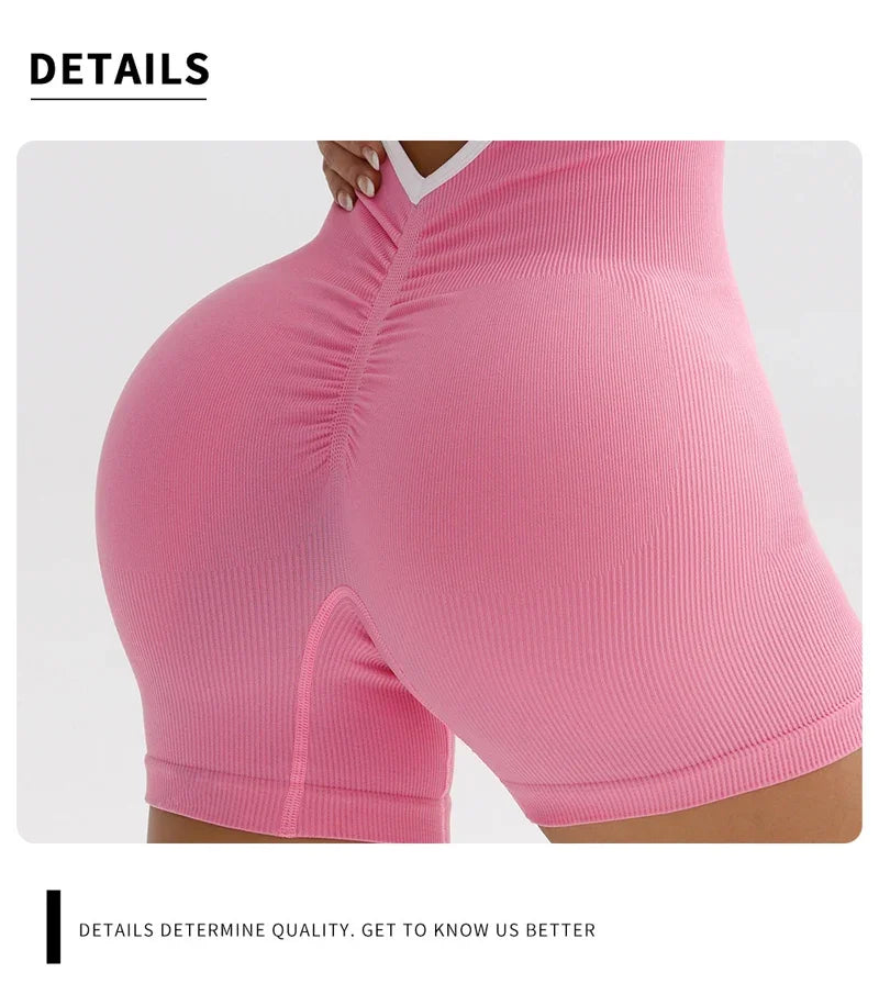 Close-up of pink cross back strappy jumpsuit showing ribbed texture and fitted design on lower body