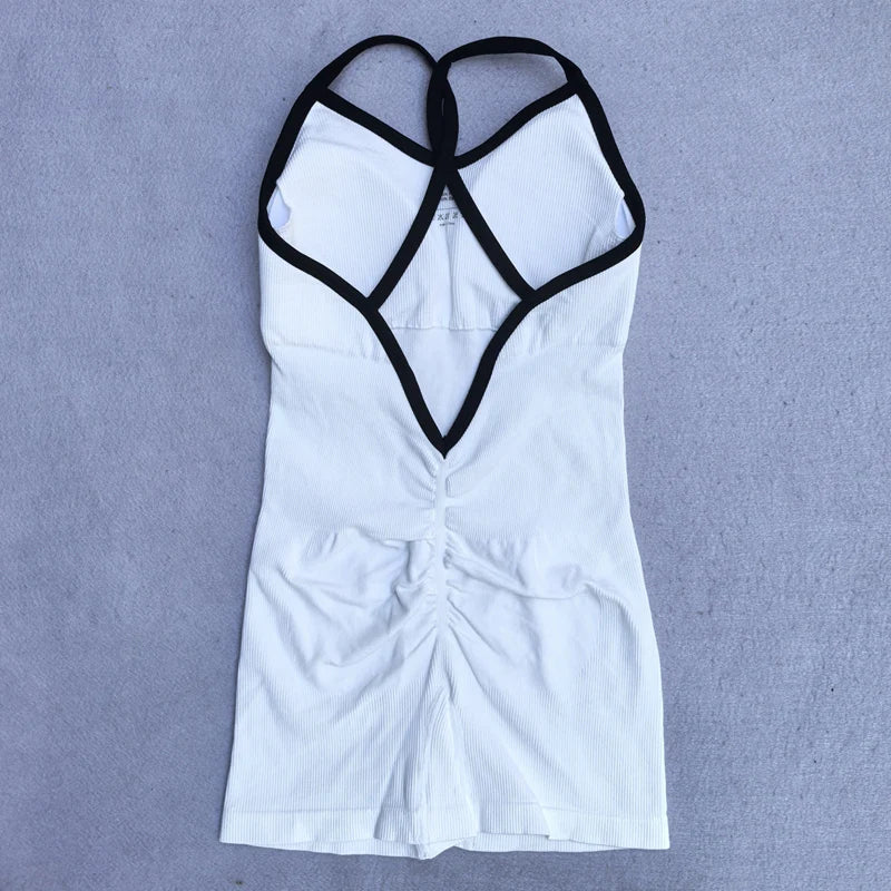 White cross back strappy jumpsuit with black trim and ruched detailing by KiKis laid flat