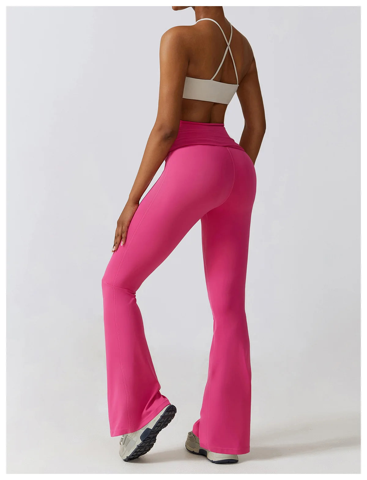 KiKis one piece yoga suit for women in vibrant pink with high waist and flared legs shown from the back