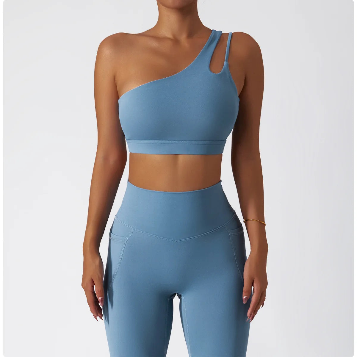 KiKis one shoulder sports bra and leggings set in blue with a cutout strap design