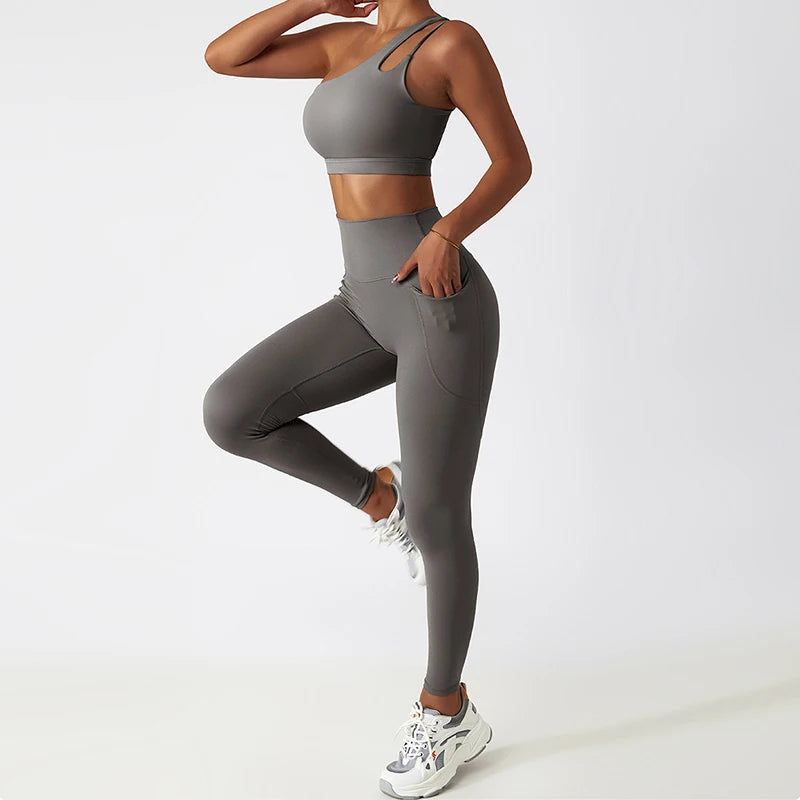 KiKis one shoulder sports bra and leggings set in gray with high waist and side pocket for activewear