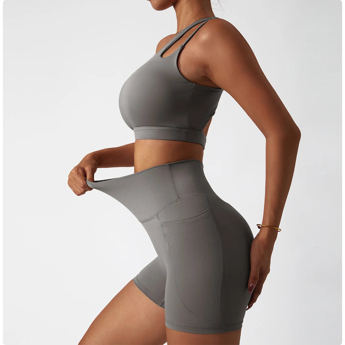 Gray one shoulder sports bra and leggings set by KiKis stretchy and fitted activewear