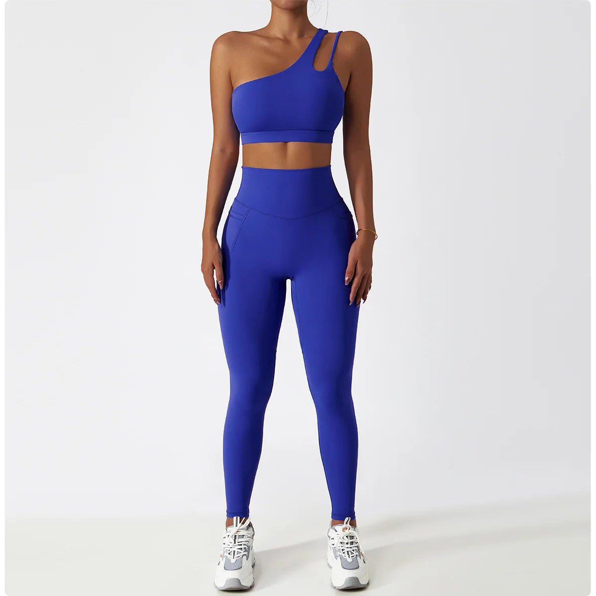 KiKis one shoulder sports bra and leggings set in blue worn by a woman with white sneakers