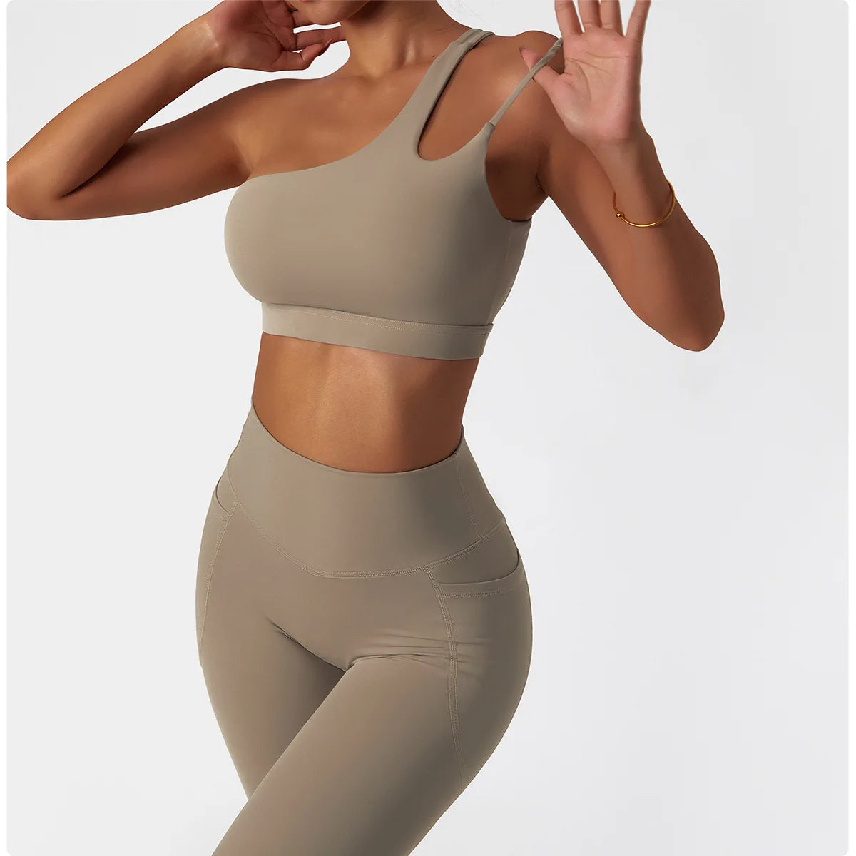 KiKis beige one shoulder sports bra and leggings set with seamless design and high waist fit