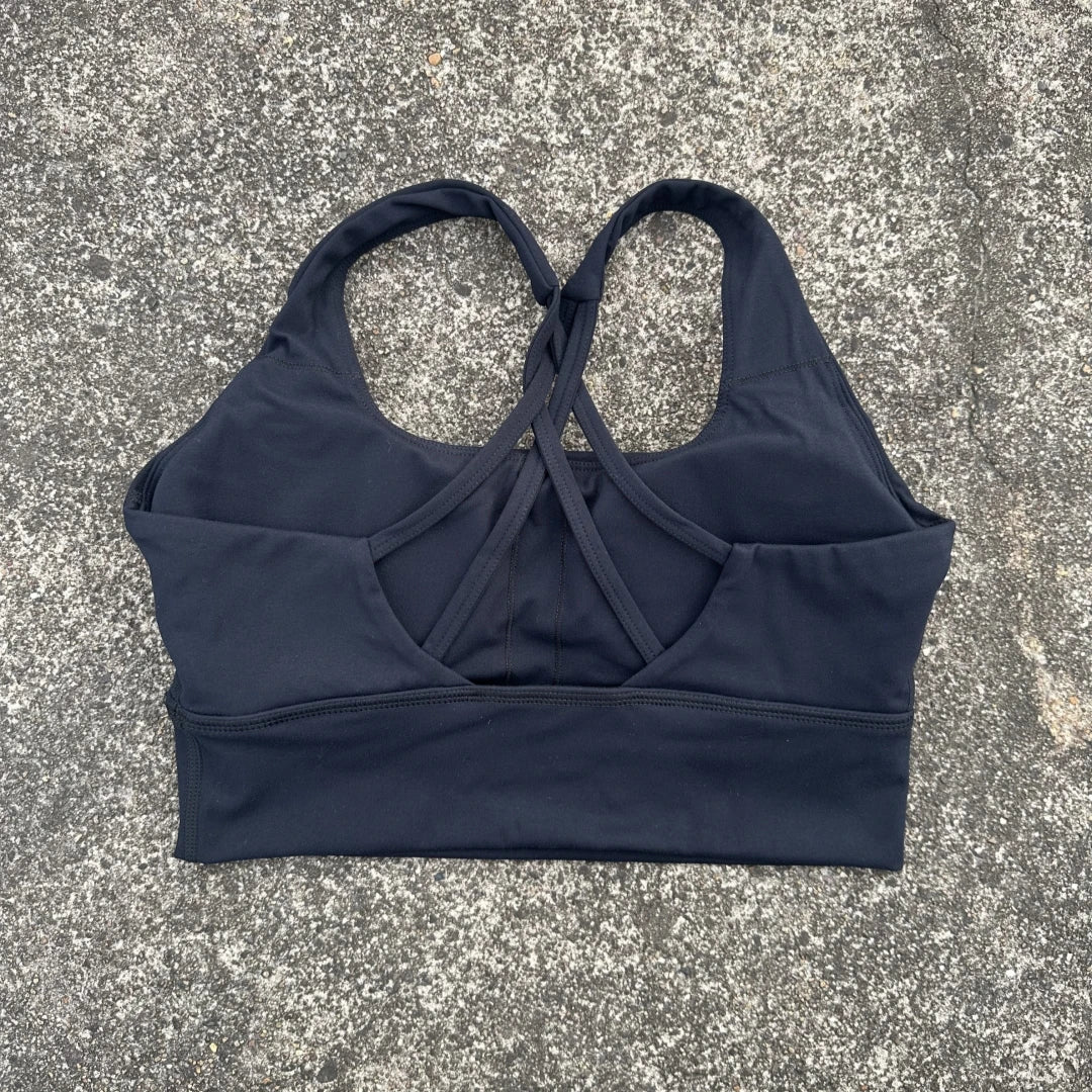KiKis black cross back sports bra for women with strappy design and supportive fit