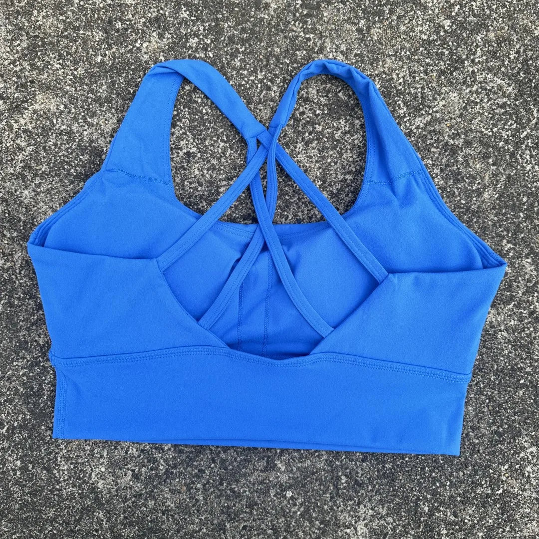 Blue cross back sports bra for women by KiKis with supportive straps and comfortable fit