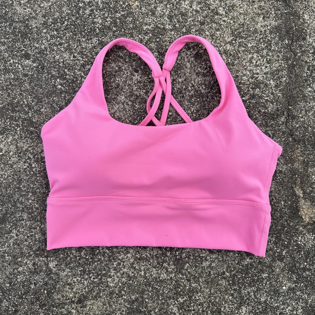 KiKis pink cross back sports bra for women with soft fabric and supportive fit