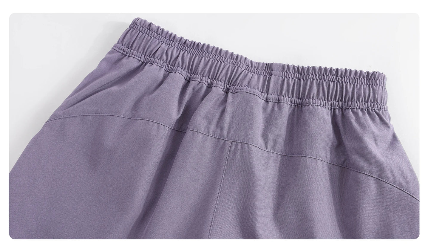 Close-up of purple KiKis high waist running shorts for women showing elastic waistband detail