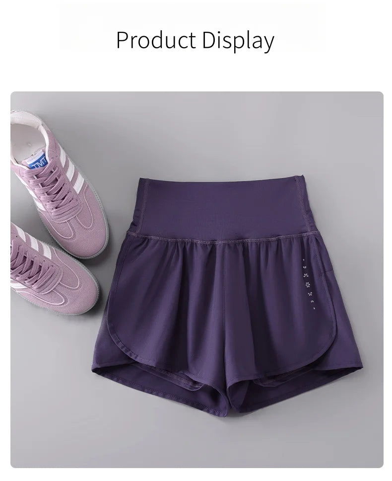 KiKis womens running shorts in purple with high waist and breathable fabric next to pink running shoes