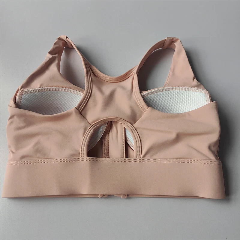 KiKis high impact front zipper sports bra in light pink with padded cups and wide straps