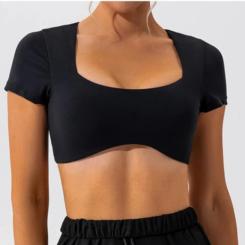 KiKis women's short sleeve sports crop top in black with a square neckline and fitted style
