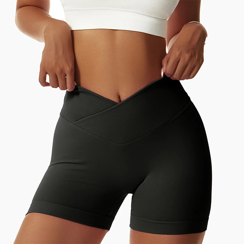 KiKis black high waist seamless yoga shorts with crossover waistband on woman