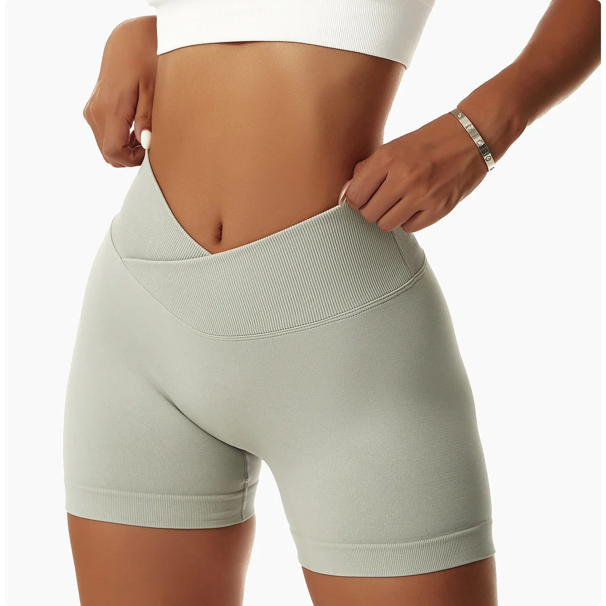 KiKis high waist seamless yoga shorts in light gray worn by woman showing waistband detail
