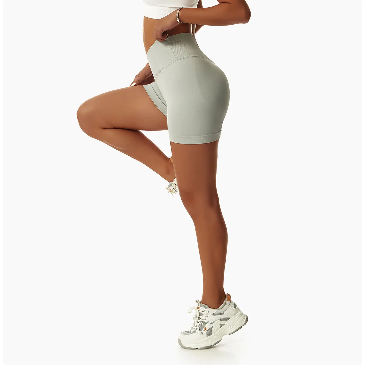 KiKis high waist seamless yoga shorts in light green modeled with white sneakers