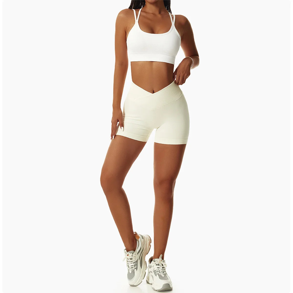 KiKis high waist seamless yoga shorts in light beige worn with white sports bra and sneakers
