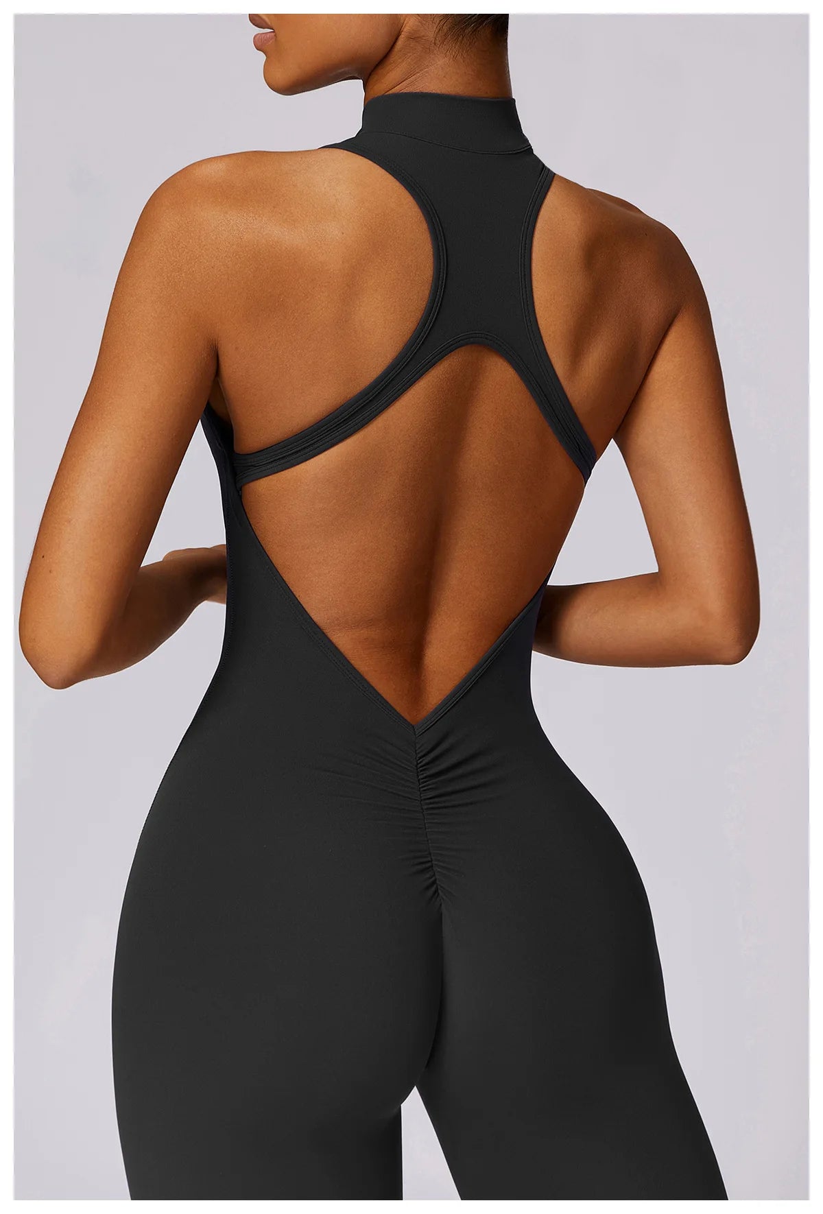 KiKis black v back one-piece yoga suit showing open back design and ruched detail