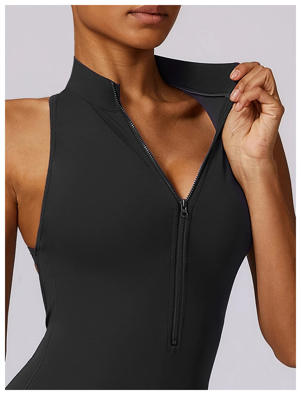 KiKis black v back one-piece yoga suit with front zipper and sleeveless design