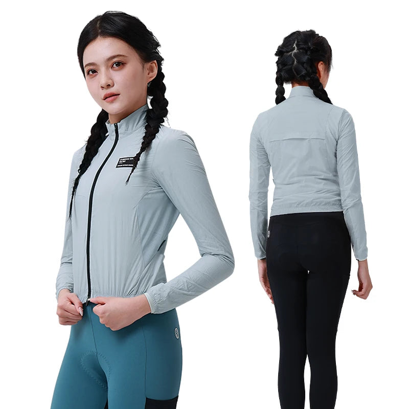 KiKis women's cycling windbreaker in light gray shown from front and back on model with braided hair