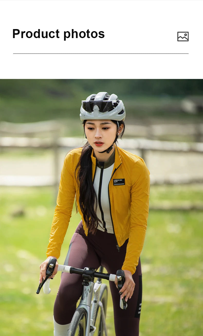 KiKis women's cycling windbreaker in mustard yellow worn by cyclist outdoors on bike